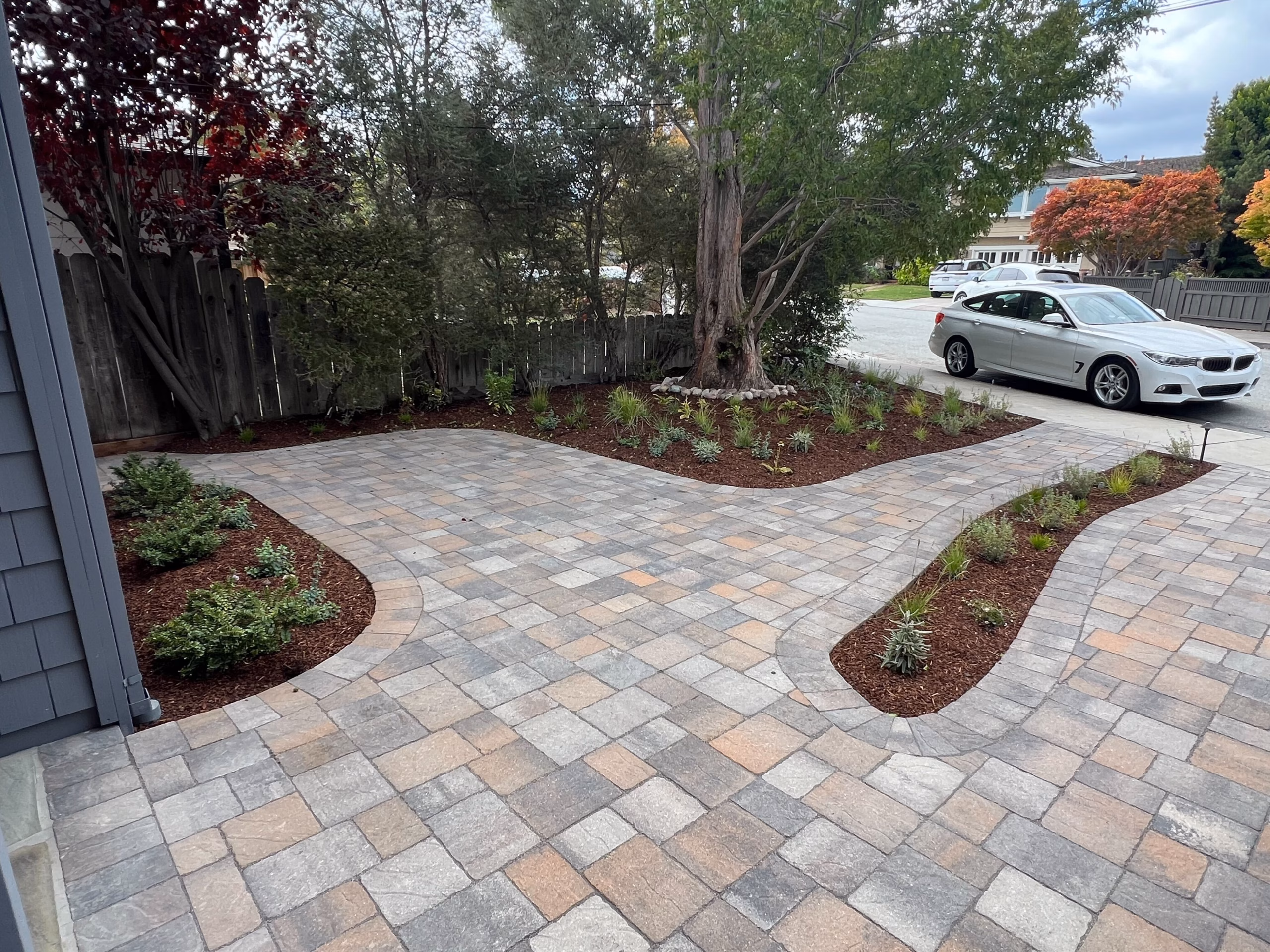 Interlocking pavers in a mixed-size ashlar pattern forming a new driveway field with clean joints in San Carlos.