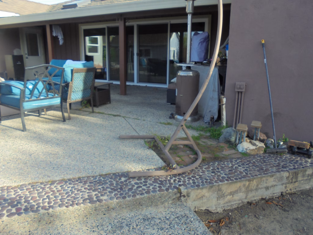 Before — aggregate patio/pool edge condition.