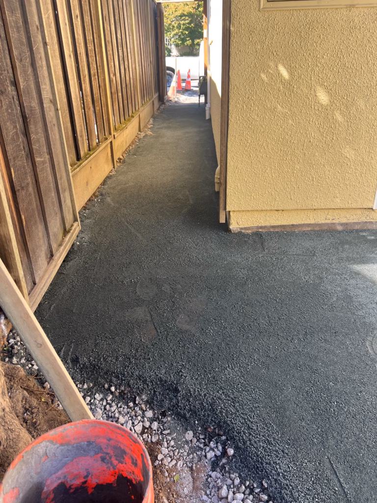 Base prep and side-yard concrete work.
