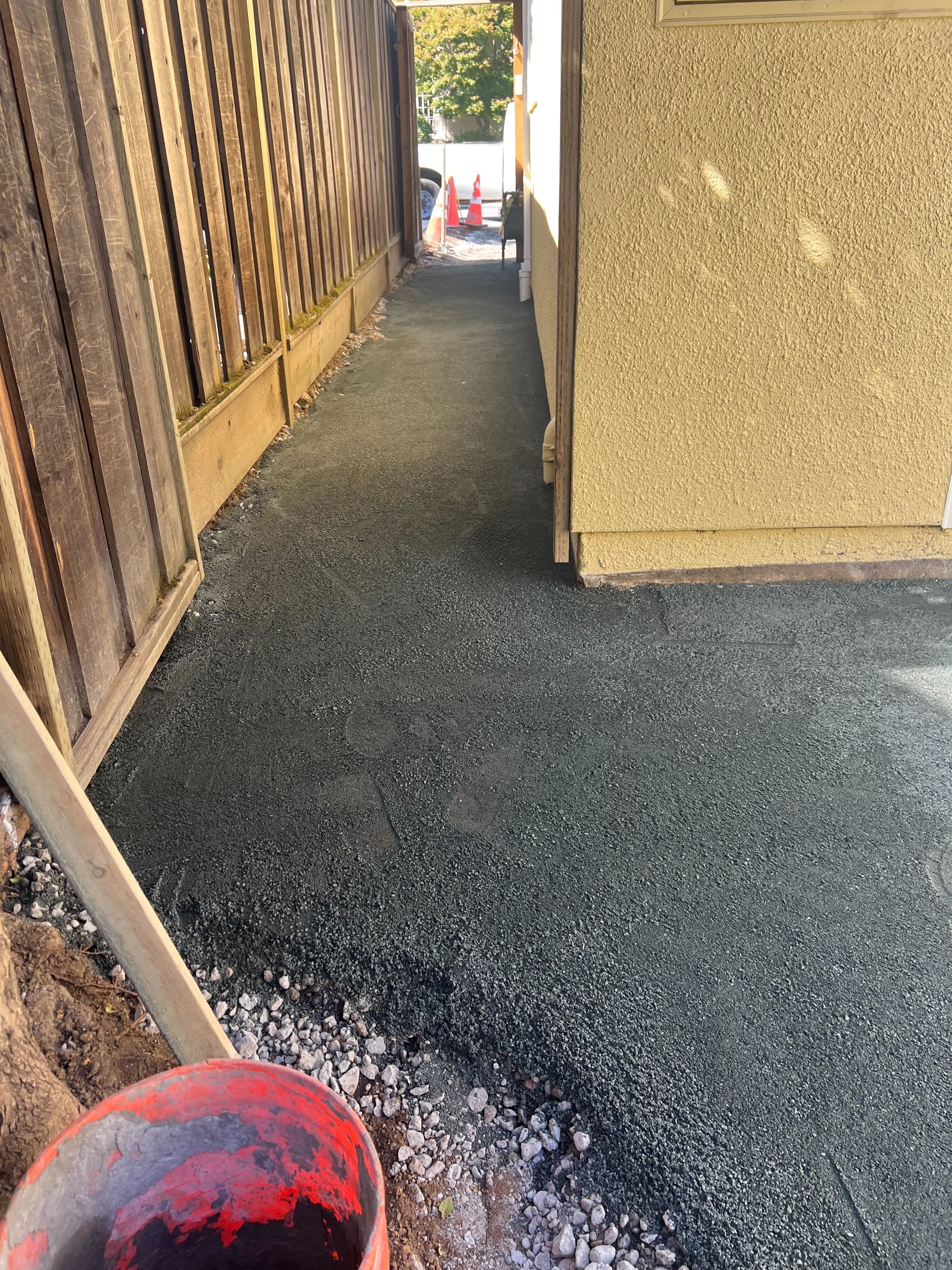Base prep and side-yard concrete work.