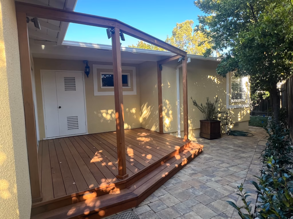 Finished rear patio/deck walkout view; clear completed hardscape.
