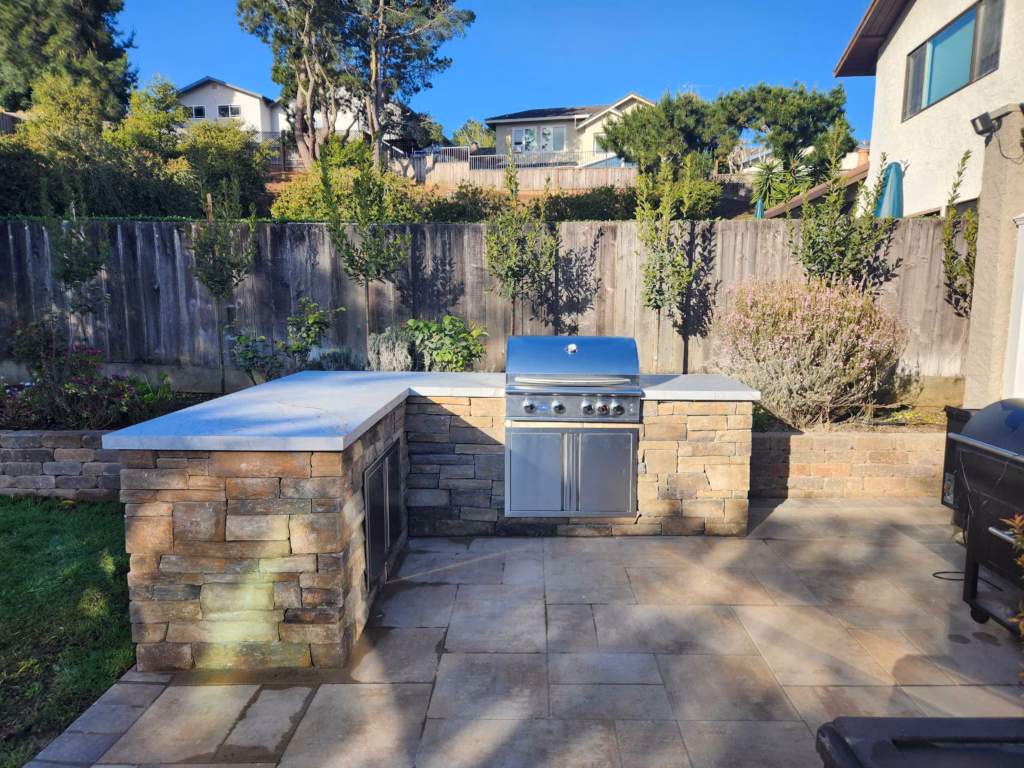 A Belmont Backyard Built Around a Stone Outdoor Kitchen