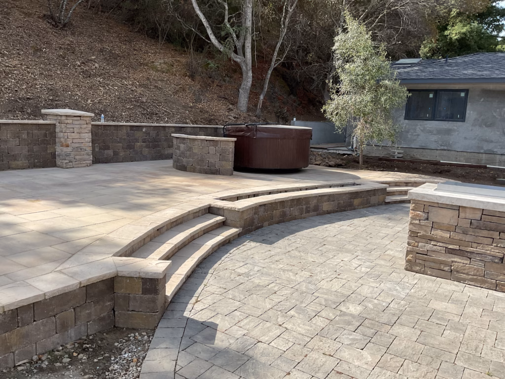Paver Terrace, Stone Walls and Outdoor Kitchen on a San Mateo Hillside