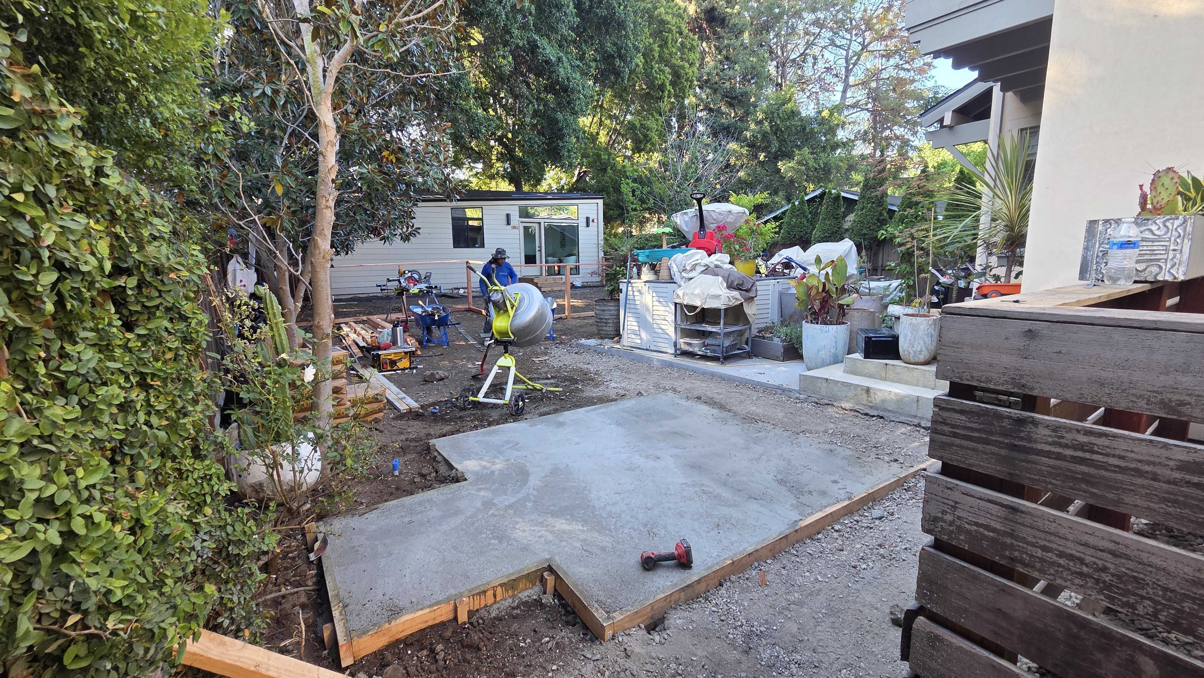 Pouring the concrete pad on a gravel base during the backyard build.