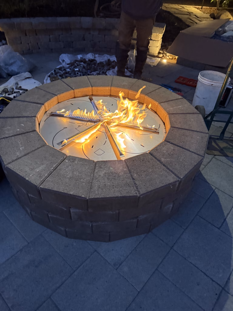 First fire in the rebuilt pit with the Elements gas burner at dusk in Atherton, CA