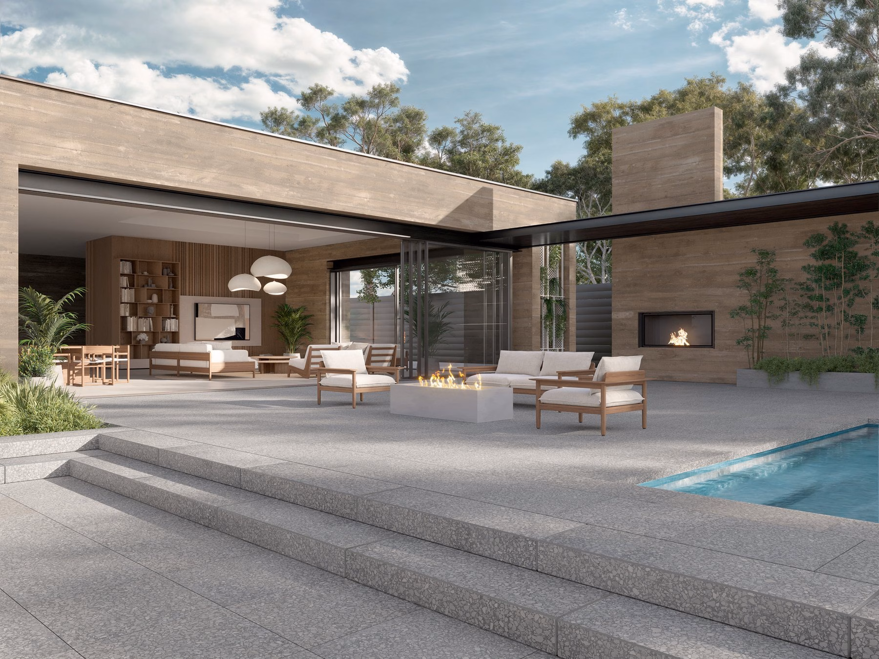 Modern estate outdoor living space with a large-format paver terrace, pool, fire table and covered outdoor room. Techo-Bloc design concept.