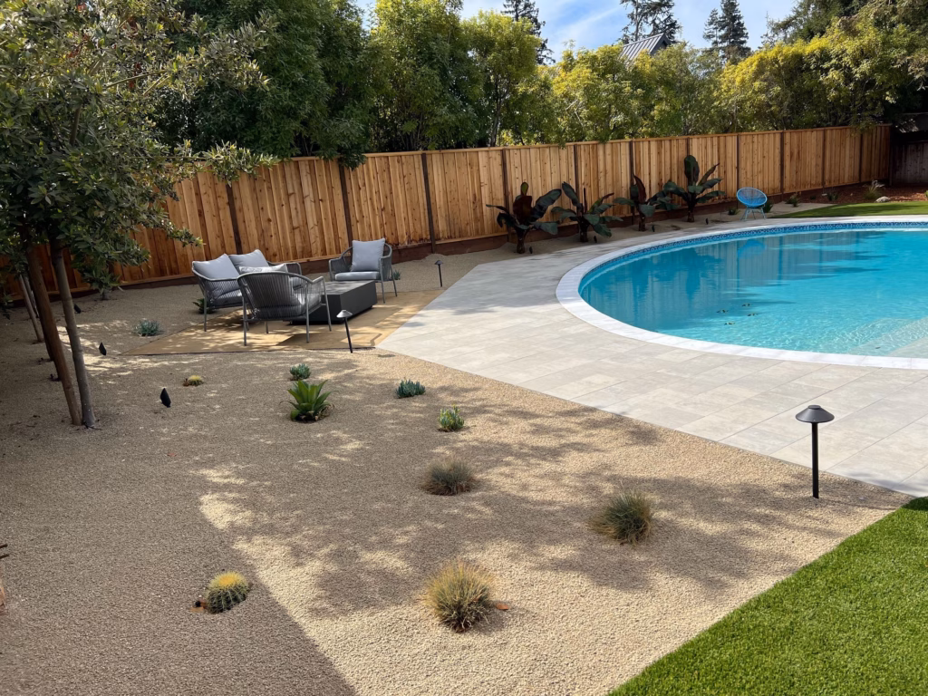 After — new paver deck, pea gravel planting and lounge corner around the same kidney pool in Los Altos, CA