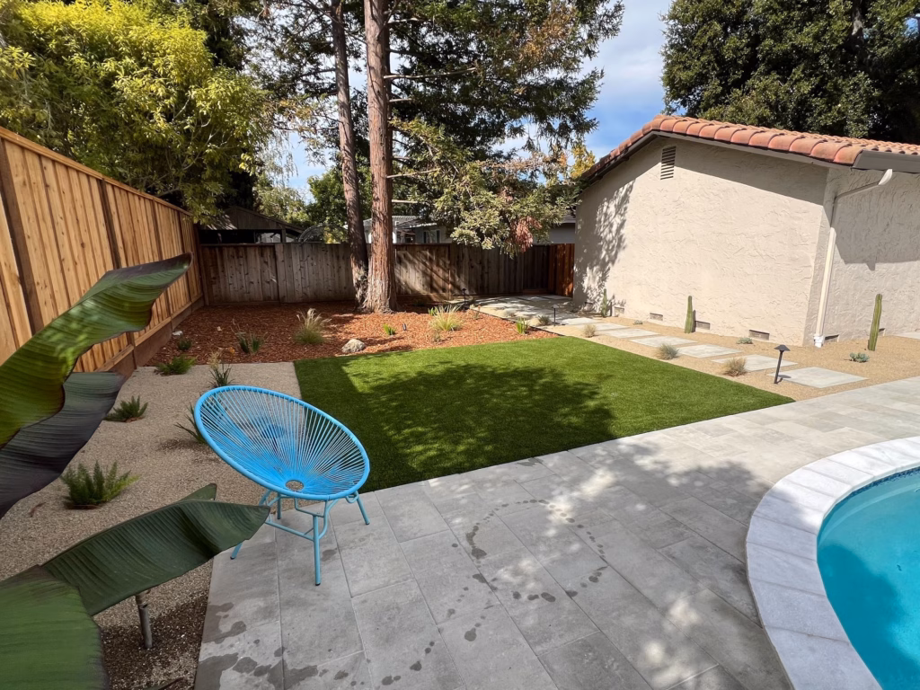 Turf lawn corner with young planting beside the new paver deck in Los Altos, CA