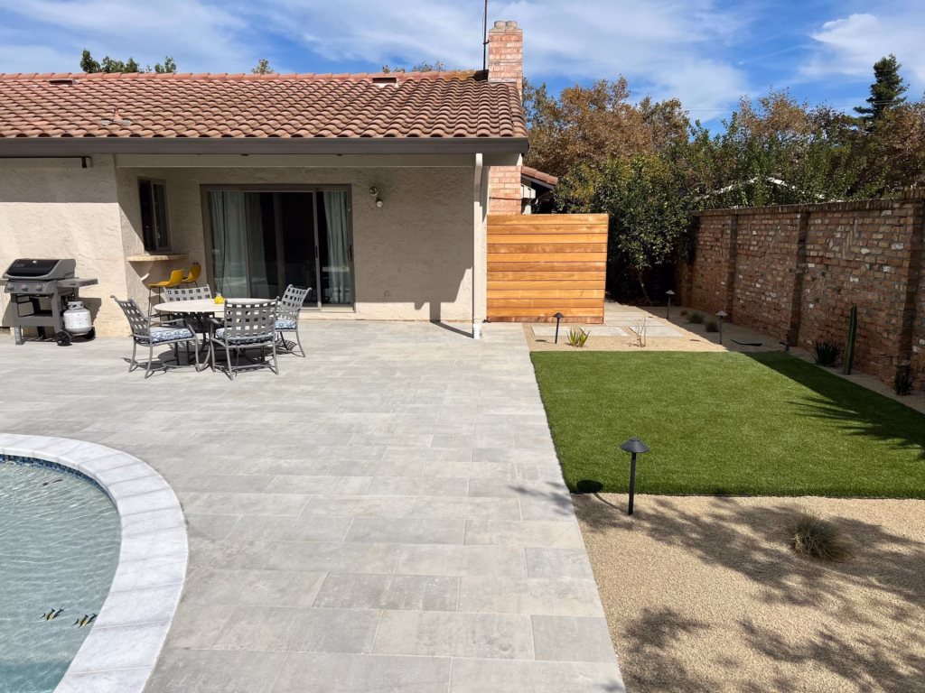 Outdoor dining set on the new Belgard paver terrace beside the pool in Los Altos, CA