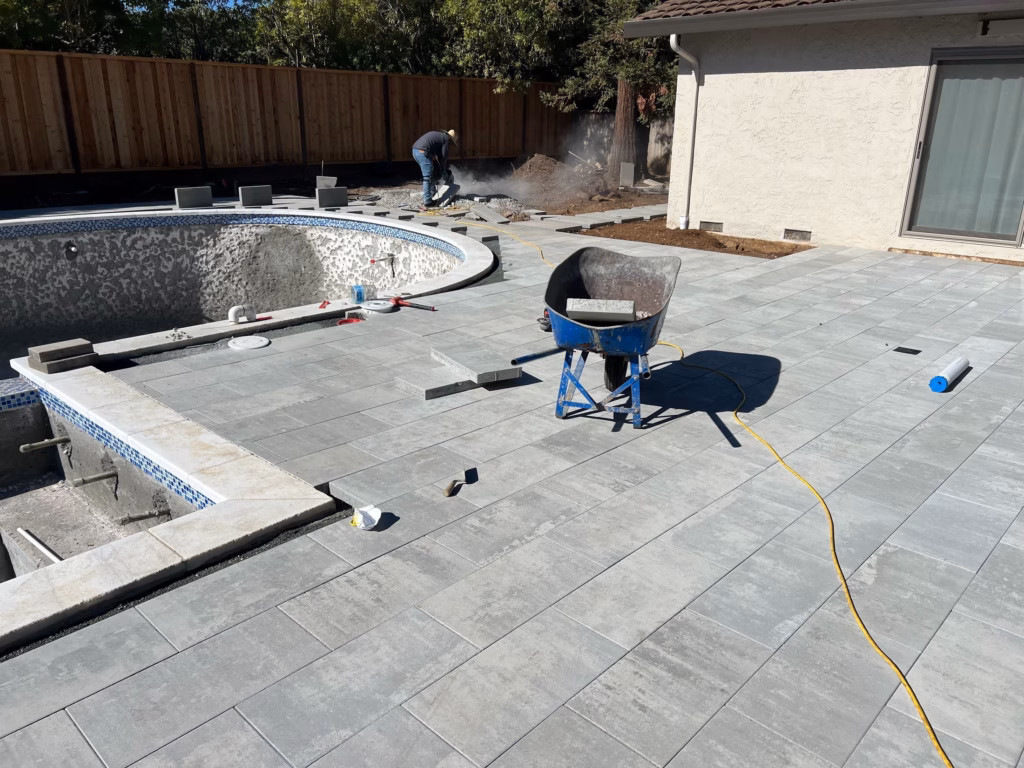 Belgard Dimensions pavers being installed around the pool curve in Los Altos, CA
