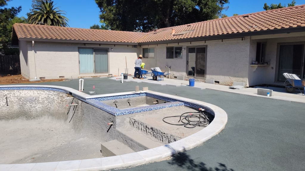 Pool contractor's renovation in progress while the surrounding yard is graded in Los Altos, CA